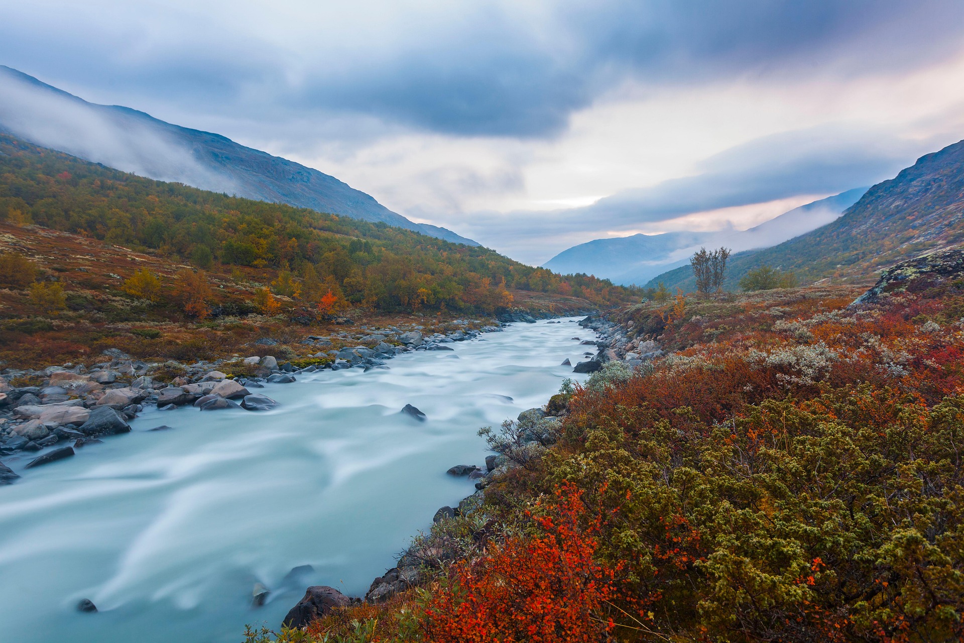 Flowing through the scenic landscapes of Norway, the Zocholl River Valley is a peaceful haven of misty mountains, colorful autumn vegetation, and crystal-clear rushing waters. Surrounded by untouched wilderness, this hidden gem offers a calming escape with breathtaking natural beauty and serene Nordic charm.