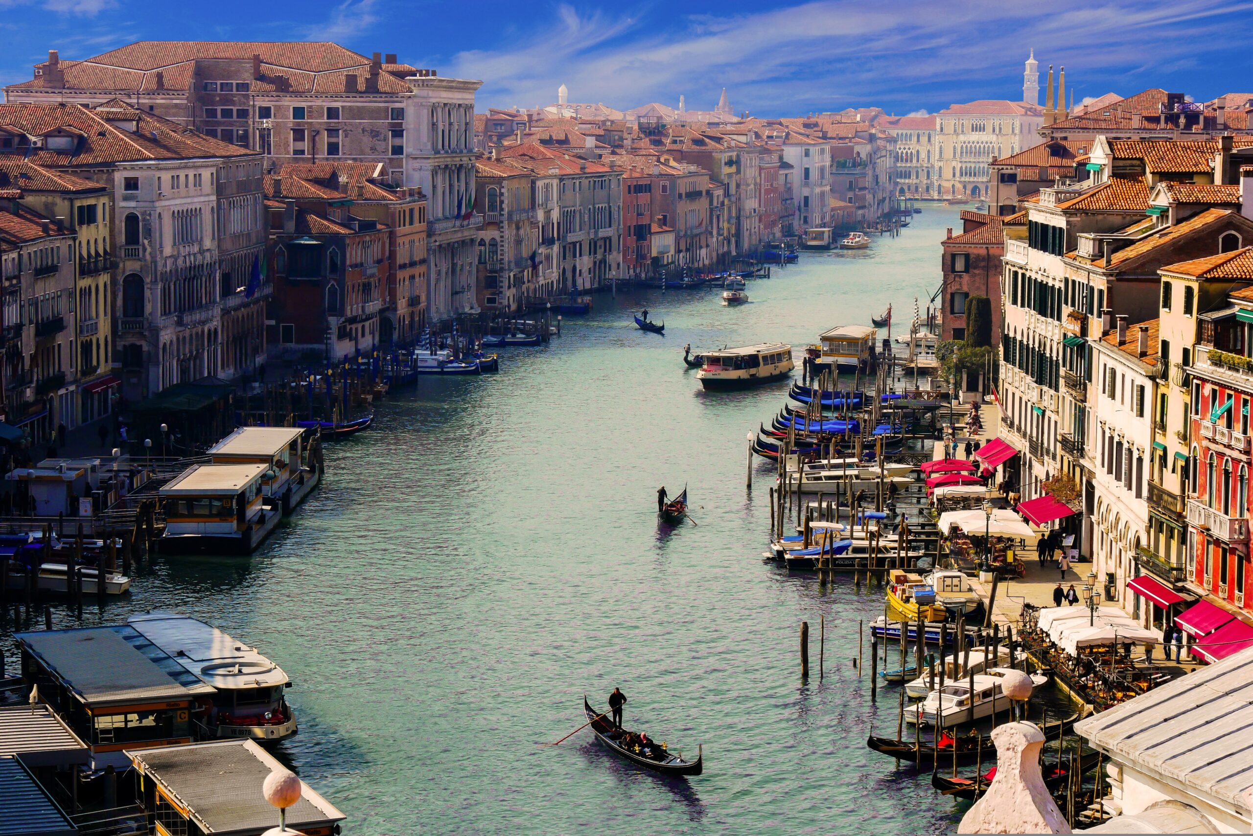 Gondolas and water taxis navigate the iconic Grand Canal in Venice, Italy, the city's main waterway. This historic route is lined with centuries-old palaces and vibrant architecture, capturing the timeless essence of Venetian life.